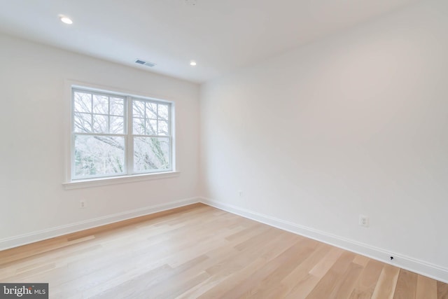 unfurnished room with light hardwood / wood-style flooring