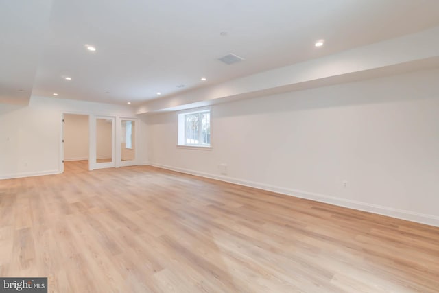 basement with light hardwood / wood-style floors