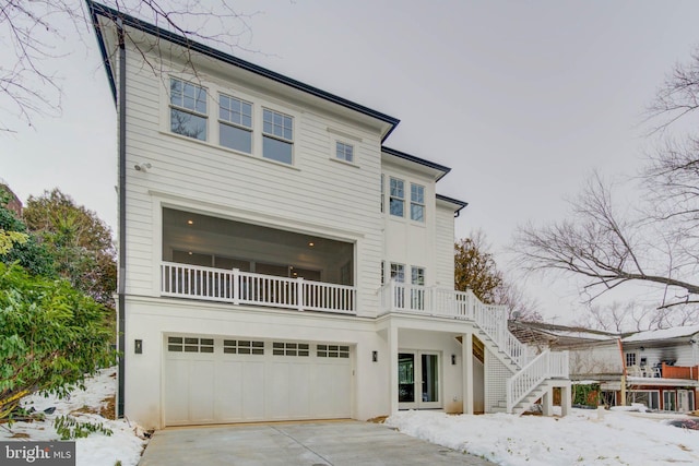 view of front of house featuring a garage and a balcony