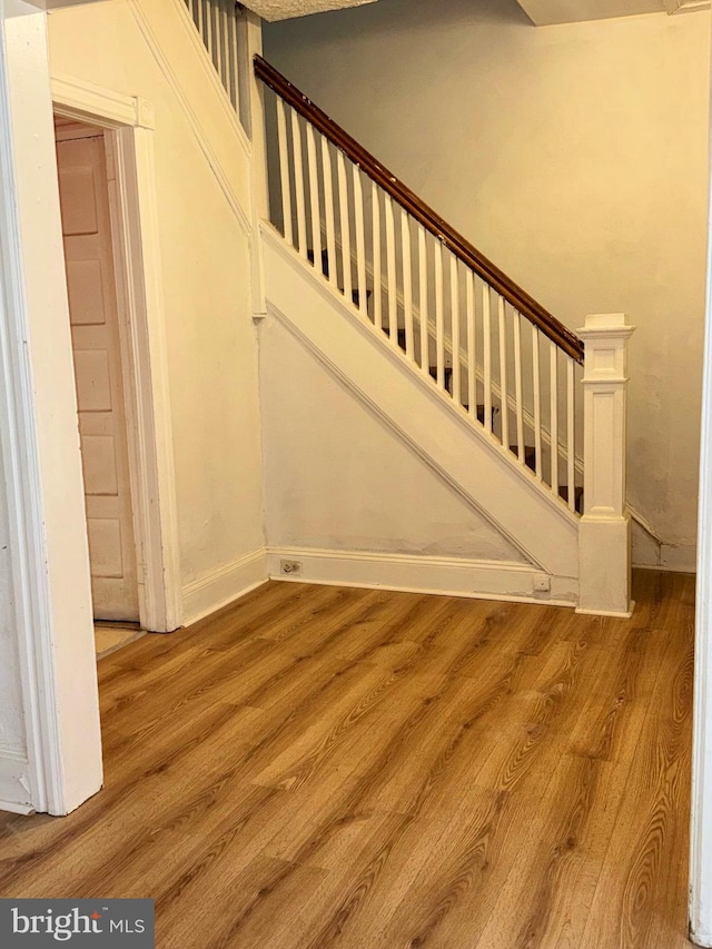 stairs featuring hardwood / wood-style floors