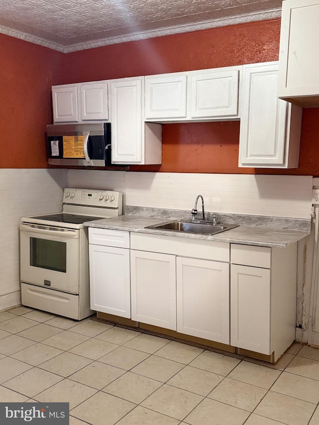 kitchen with a textured ceiling, white cabinetry, white electric stove, sink, and light tile patterned floors