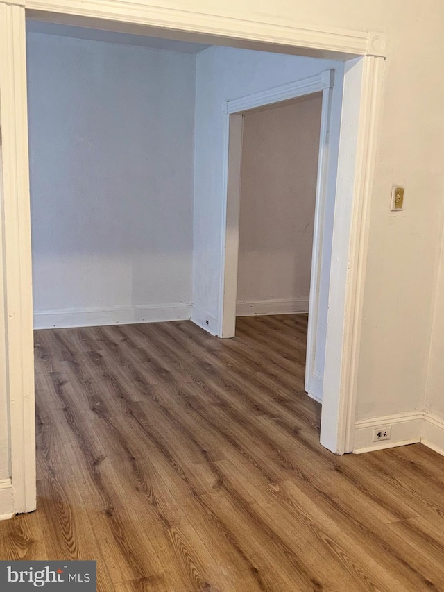 spare room featuring dark wood-type flooring