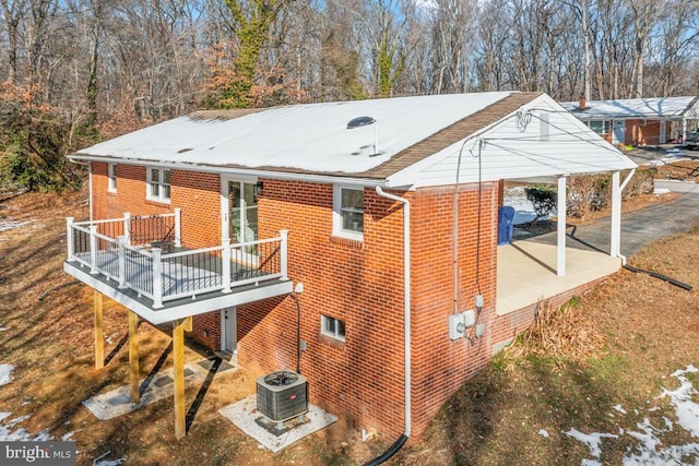 rear view of property with central AC unit