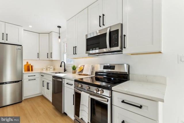 kitchen featuring white cabinets, appliances with stainless steel finishes, and sink