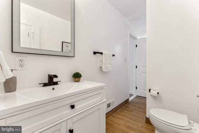 bathroom with toilet and vanity