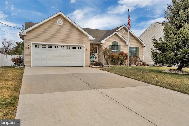 ranch-style house featuring a front yard and a garage