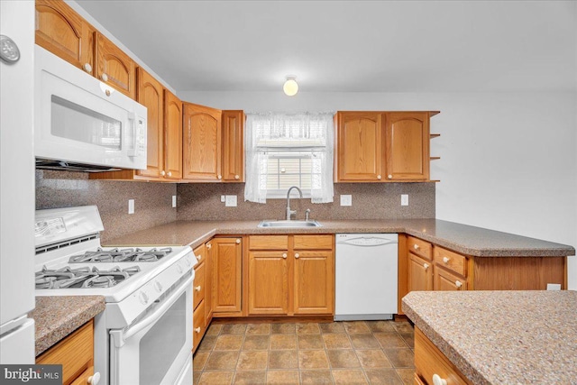 kitchen with decorative backsplash, sink, and white appliances