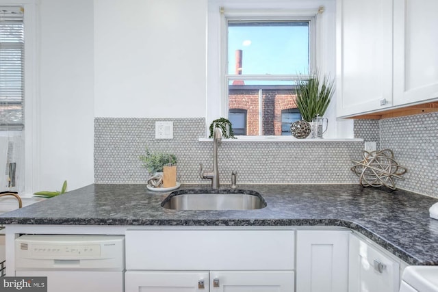 kitchen featuring white cabinetry, sink, a wealth of natural light, and white dishwasher