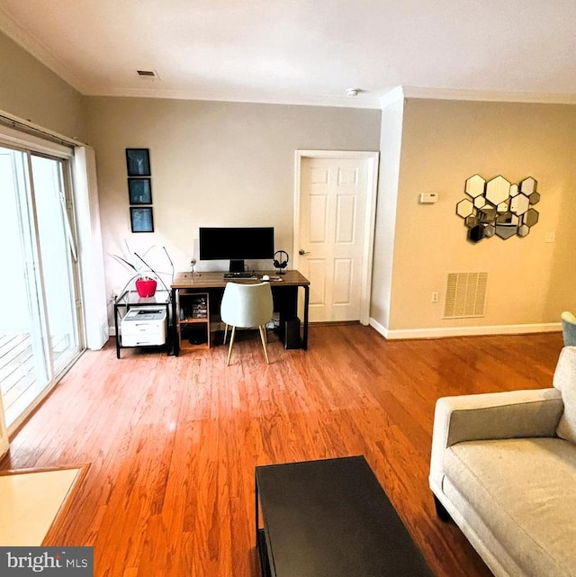 office space with hardwood / wood-style floors, crown molding, and plenty of natural light