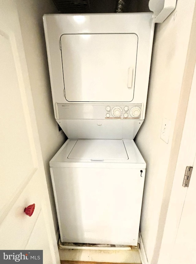 laundry room featuring stacked washer and clothes dryer