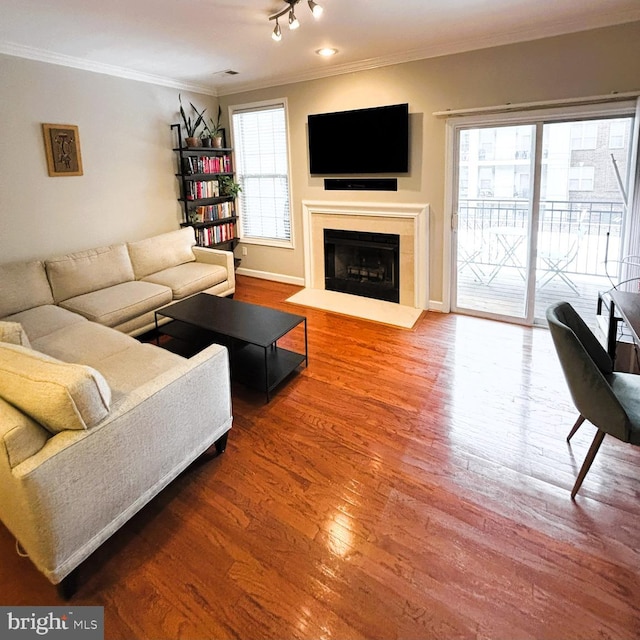 living room featuring hardwood / wood-style flooring and crown molding