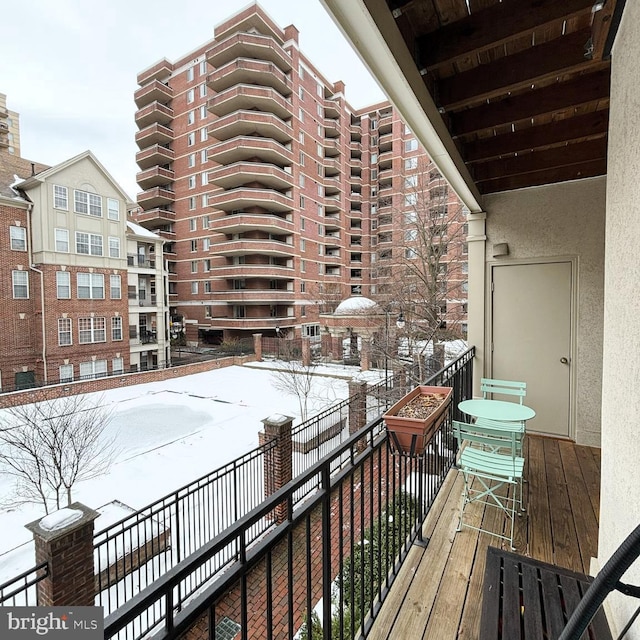 view of snow covered back of property