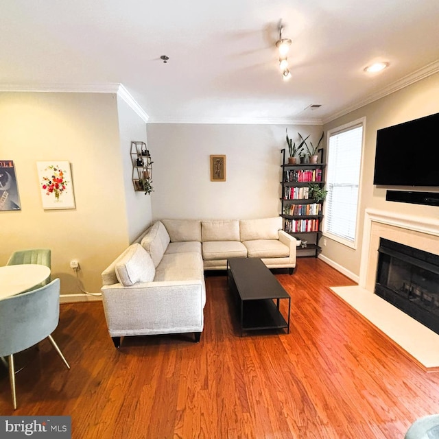 living room with crown molding and hardwood / wood-style flooring