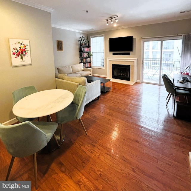 living room with hardwood / wood-style floors and crown molding