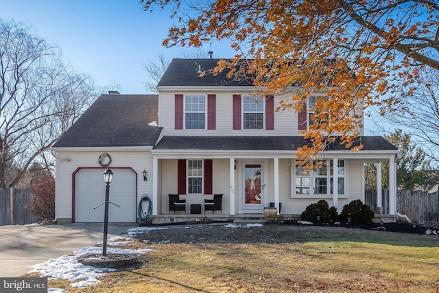 front facade with a front yard, a porch, and a garage