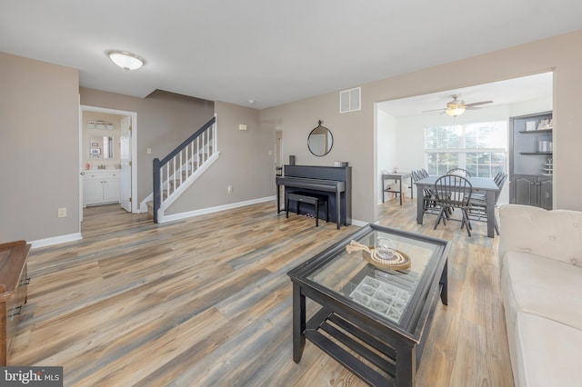 living room with ceiling fan and wood-type flooring