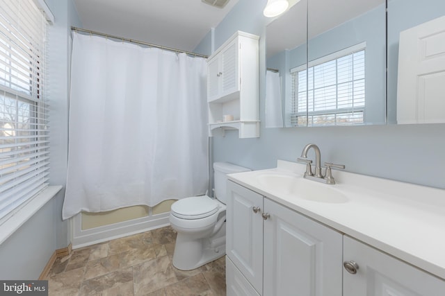 full bathroom featuring toilet, vanity, and shower / bath combo with shower curtain