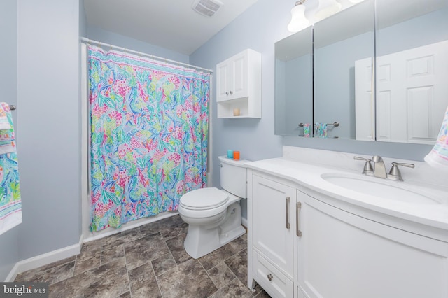 bathroom with toilet, vanity, and curtained shower