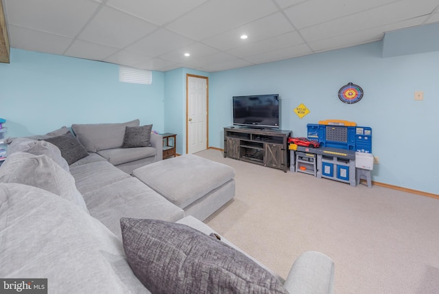 carpeted living room featuring a paneled ceiling