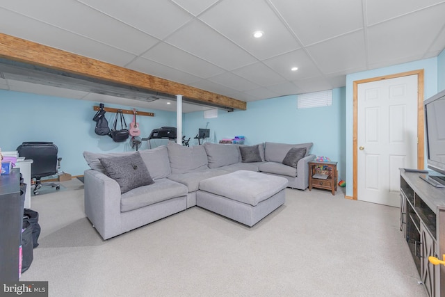 carpeted living room with a paneled ceiling