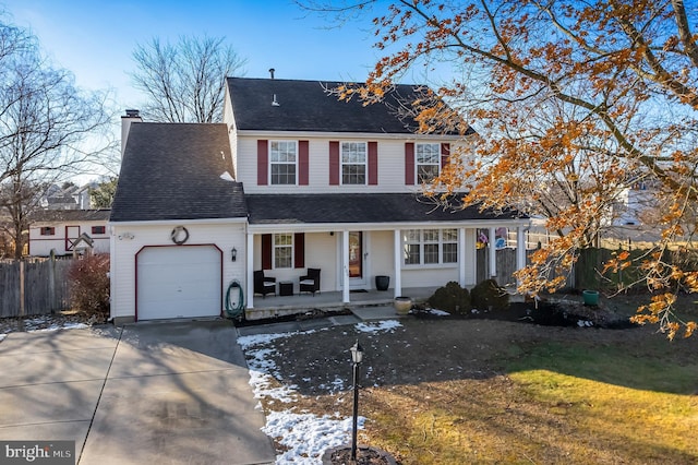 view of front property with covered porch and a garage