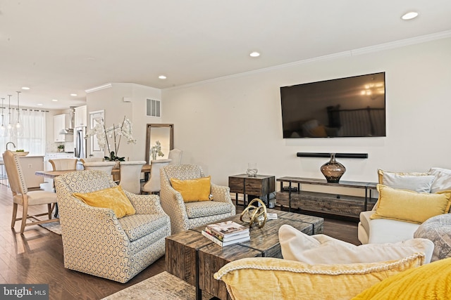 living room with dark wood-type flooring and crown molding