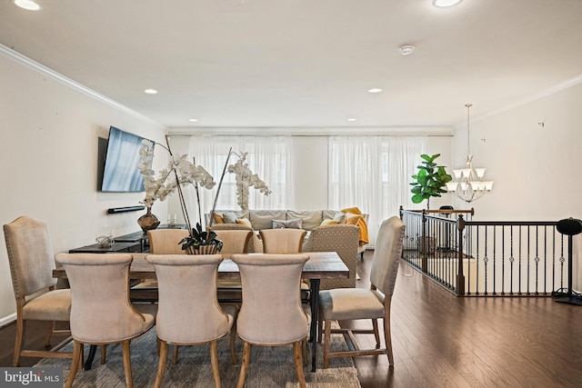 dining room featuring dark hardwood / wood-style flooring, a notable chandelier, and ornamental molding