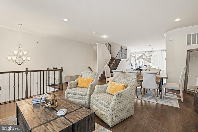 living room featuring ornamental molding, a notable chandelier, and dark hardwood / wood-style flooring