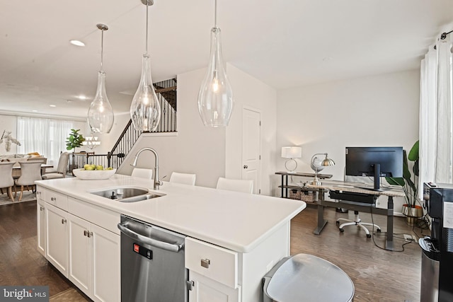 kitchen featuring pendant lighting, sink, dishwasher, a kitchen island with sink, and white cabinetry