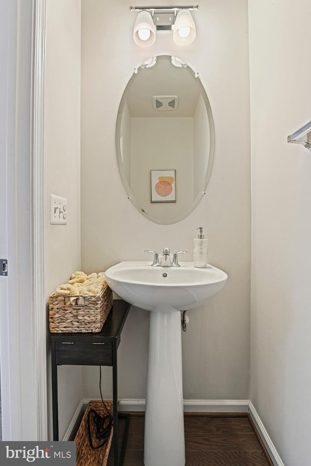 bathroom with wood-type flooring