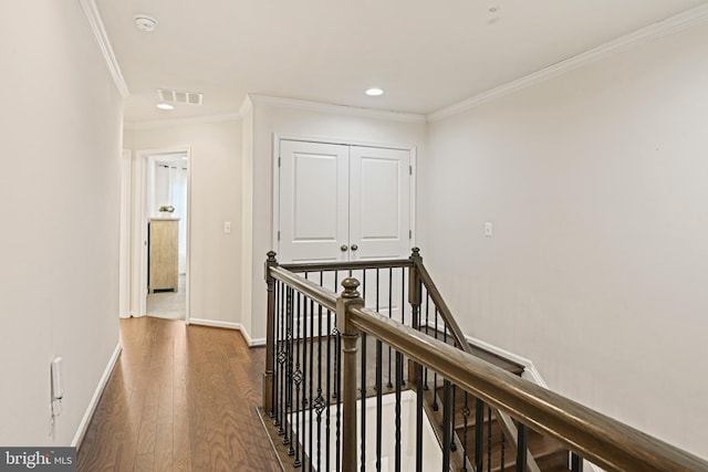 hallway with dark wood-type flooring and ornamental molding