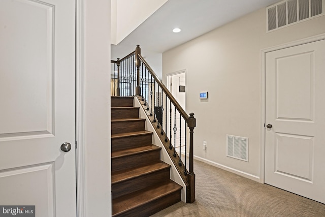 stairs featuring carpet