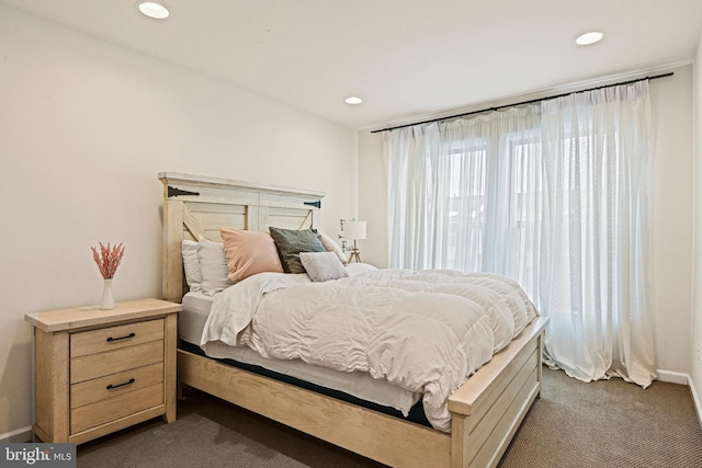 bedroom with dark colored carpet