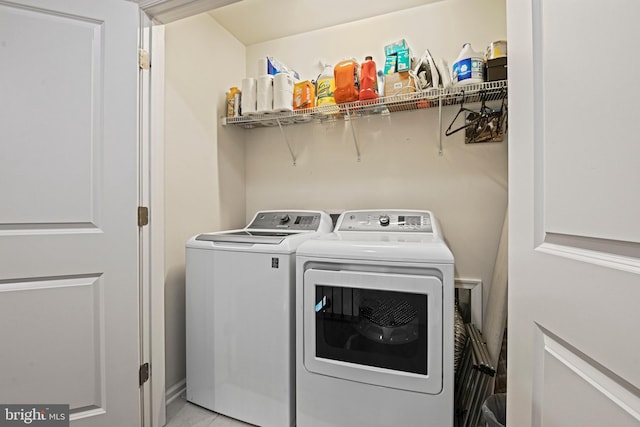 laundry area featuring washing machine and clothes dryer