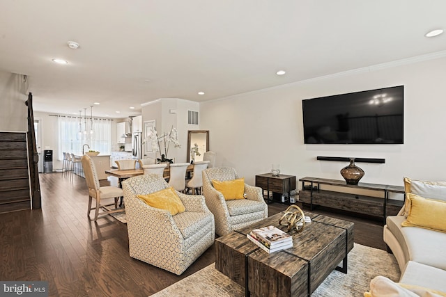 living room featuring dark wood-type flooring and ornamental molding