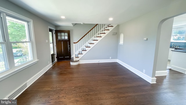 entryway with a baseboard heating unit and dark wood-type flooring