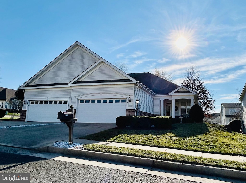 view of front of house with a garage and a front yard