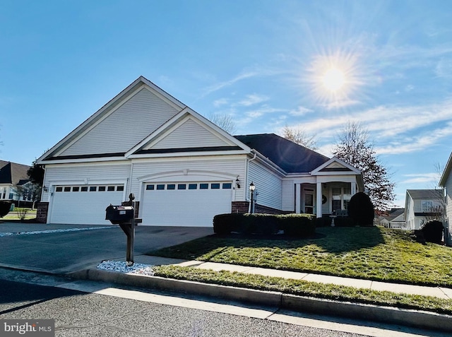 view of front of house with a garage and a front yard