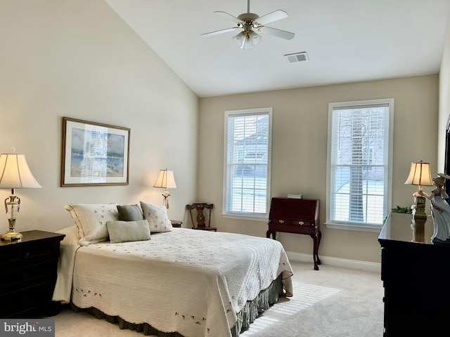 carpeted bedroom with multiple windows, vaulted ceiling, and ceiling fan