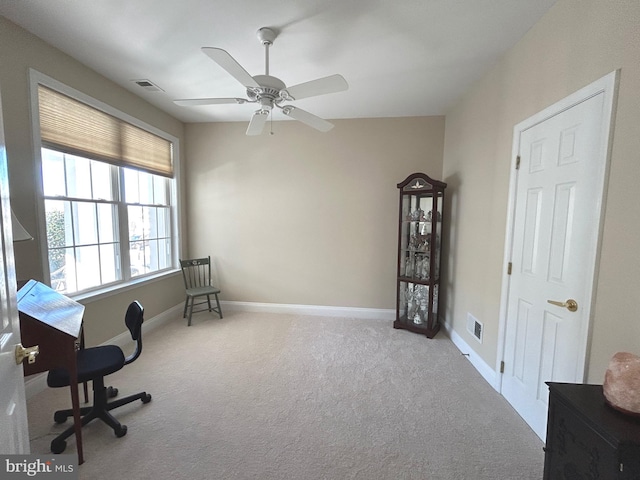 office with light carpet and ceiling fan