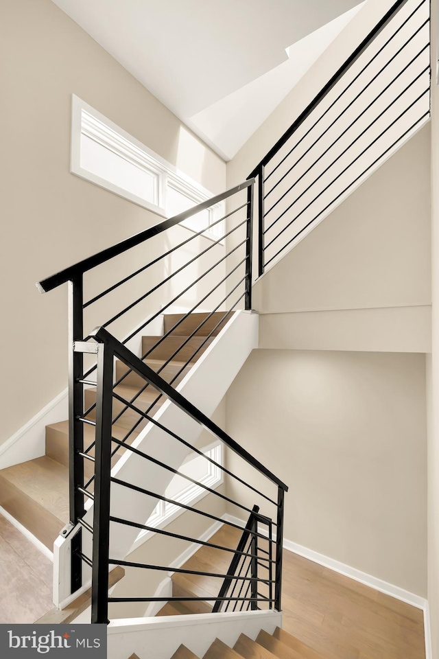 staircase with hardwood / wood-style flooring