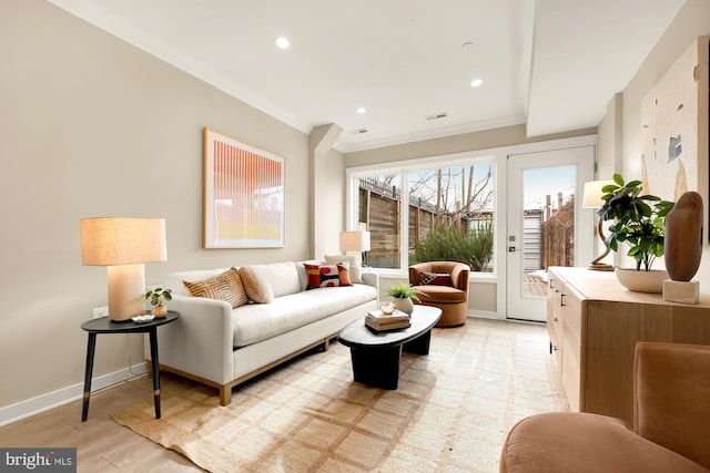 living room featuring crown molding and light hardwood / wood-style flooring