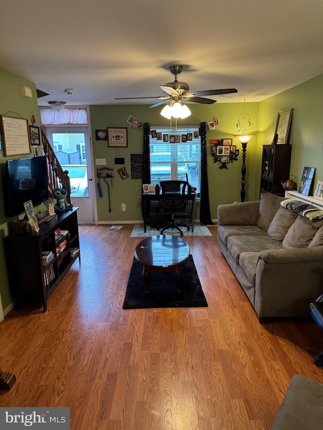 living room with ceiling fan and hardwood / wood-style floors