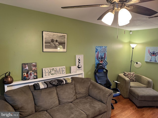 living room featuring ceiling fan and light hardwood / wood-style flooring