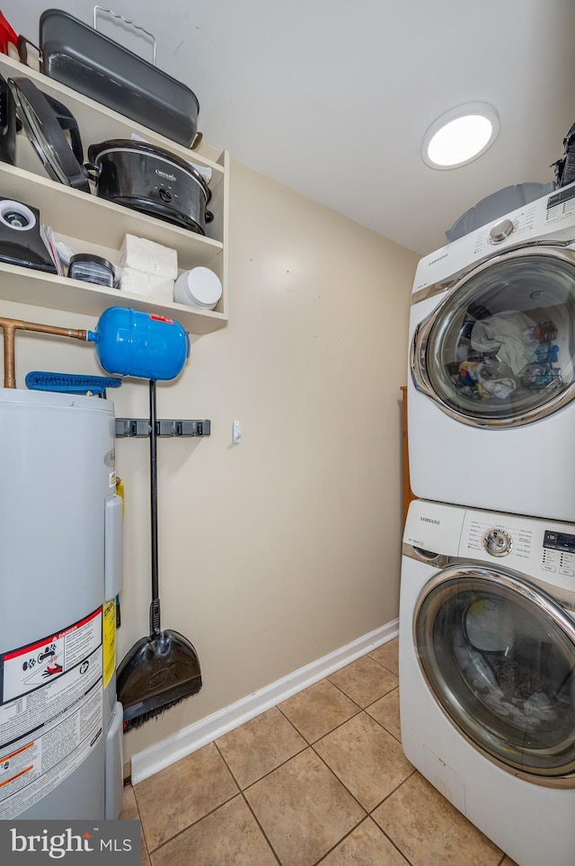 laundry area with stacked washer / dryer, electric water heater, and light tile patterned flooring