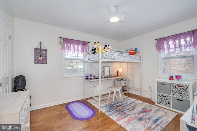 bedroom with hardwood / wood-style flooring and ornamental molding