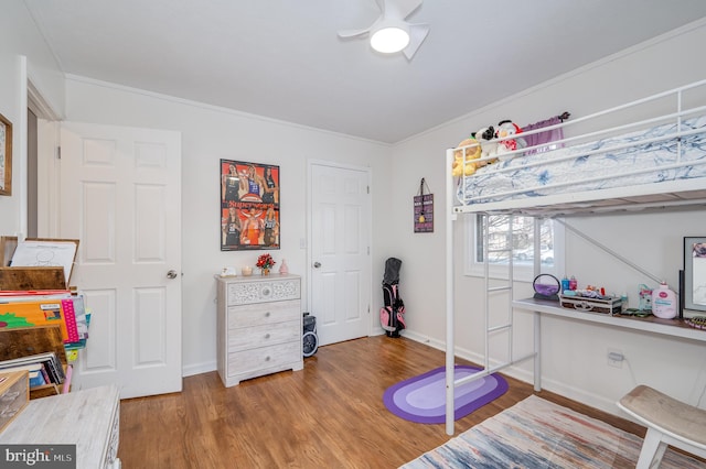 bedroom with crown molding and hardwood / wood-style floors