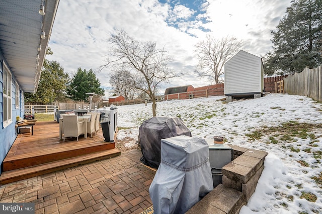 exterior space with a deck and a grill