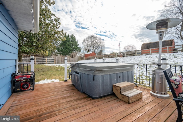 snow covered deck with a hot tub