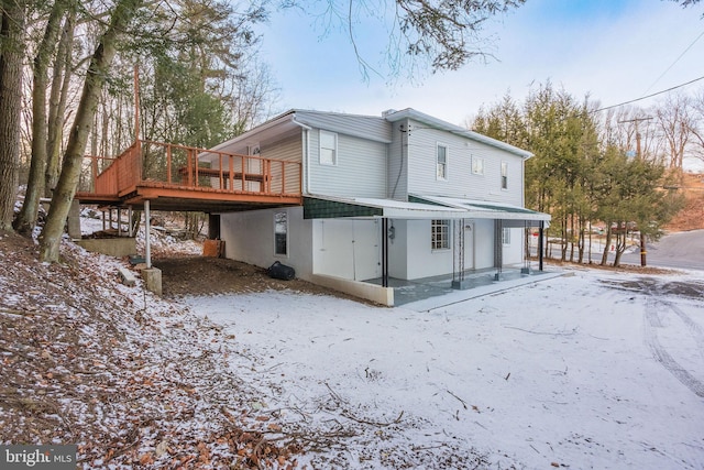 view of snow covered rear of property